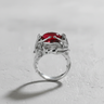 925 sterling silver nymph ring featuring three female figures holding a red cabochon stone