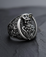 Sterling silver pirate skull ring featuring an undead captain with a tentacle beard, shown on a dark slate surface.