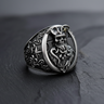 Sterling silver pirate skull ring featuring an undead captain with a tentacle beard, shown on a dark slate surface.