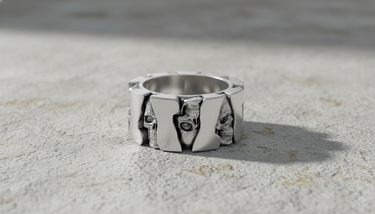 925 sterling silver skull gear ring featuring alternating skull faces and polished panels on stone surface