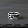 Front view of 925 sterling silver tree branch ring with intricate root design on dark stone background
