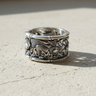 Side view of silver tiger ring showing textured fur details and bamboo leaves in sterling silver