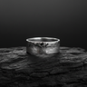 925 sterling silver raw texture ring with rugged fissure design and dark stones displayed on black charcoal background