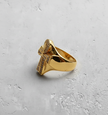 Gold vermeil silver ankh cross ring paved with clear stones on textured grey background