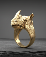 Gold vermeil silver rhinoceros ring featuring realistic skin texture and horn detail on dark stone background