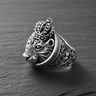 Side profile of sterling silver lion ring displaying intricate floral shank engravings and crown detail