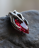 Oxidized 925 sterling silver hands pendant clasping red garnet drop stone side view detailing