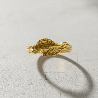 14k gold vermeil leaf ring with intricate vein details on grey stone background