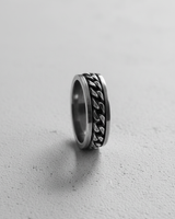 Side profile of handcrafted spinner ring showing loose chain mechanism and metal thickness