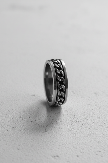 Side profile of handcrafted spinner ring showing loose chain mechanism and metal thickness