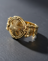 Gold vermeil silver cross ring with an intricate Byzantine design and granulated cross, shown on a dark textured surface.