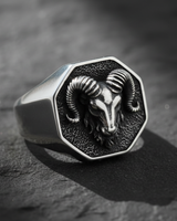 Front view of 925 sterling silver ram signet ring featuring detailed horns and oxidized background on dark stone