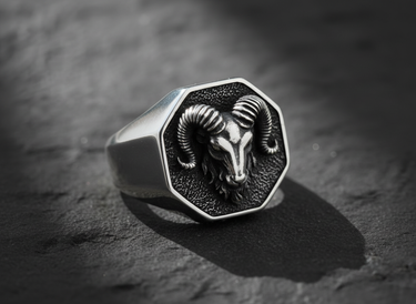 Front view of 925 sterling silver ram signet ring featuring detailed horns and oxidized background on dark stone