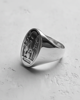 Side profile of silver Akhenaten ring highlighting brushed metal finish and intricate cartouche design