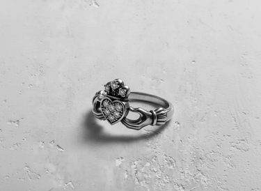 Side angle of sterling silver Irish ring with intricate stone details representing love loyalty and friendship