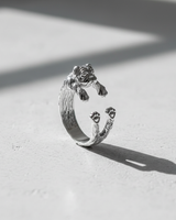 Adjustable 925 sterling silver pug ring featuring realistic dog face and wrap design on white surface