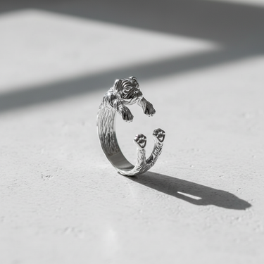 Adjustable 925 sterling silver pug ring featuring realistic dog face and wrap design on white surface