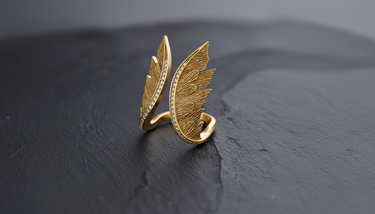 Gold vermeil angel wings ring with pave stones on the edge displayed on black texture