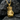 Close-up of gold vermeil boxing glove pendant resting on dark stone highlighting the polished finish