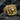 Luxurious lion head signet ring in gold vermeil resting on dark stone, displaying intricate vintage filigree band details