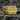 Close-up of premium 925 sterling silver razor blade ring with gold finish resting on textured grey stone surface