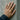 Twin panther ring worn on model hand against concrete wall