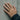 Rose Solitaire Ring worn on model hand against concrete wall