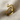 Close-up of the coiled snake ring design resting on textured fabric highlighting the serpent head detail.