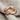 Hugging Arms Ring, rose gold, product view on linen fabric