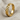Diagonal Twist Ring, gold vermeil, angled standing view on fabric