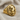 Side angle view of the knight chess ring highlighting the intricate classical floral side motifs in gold