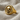 Round Skull Signet Ring, gold vermeil, angled view on fabric