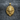 Close-up of premium handcrafted lion head pendant in 14K gold vermeil resting elegantly on a textured grey fabric