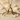 Bird Letter A Pendant, gold vermeil, product photo in sand