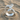 Serpent Gemstone Ring, polished silver finish on beach sand