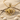 Stunning Taurus bull pendant crafted in 925 sterling silver and gold vermeil resting on textured sand with coastal shells