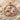 Leo Zodiac Medallion Pendant, rose gold, front view on sand and shells