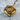 Close-up of the ethereal eye ring resting on wood, highlighting the sweeping ornate frame and luxurious finish