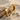 Three stone engagement ring, gold vermeil, product photo on sand