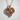 Horse Heart Pendant, rose gold, front view on textured wall