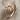 Wrap bat wing ring, rose gold plated, angled view on fabric