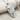 Double Horse Skull Pendant, polished silver, angled view on fabric