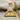 Close-up detail of the handcrafted radiant delta pendant resting on textured fabric highlighting engraved lines