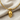 Anatomical Skull Pendant, gold vermeil, front view on linen with chain