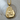 Close-up of gold vermeil Buddha hand pendant highlighting intricate carving and serene face on wooden surface