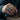 Lifestyle view of the oxidized silver male embrace ring worn on a man's hand moving a wooden chess piece