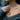Detailed angled view of oxidized silver sapphic love pendant highlighting flowing hair and romantic female figures