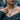 Close-up of interlocking female symbols on a handcrafted silver LGBTQ pride pendant showcasing polished edges
