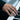 Lifestyle view of the oxidized silver Love Is Love band worn on a person's hand while playing the piano.