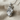 King lion crown pendant, polished silver, angled view on fabric